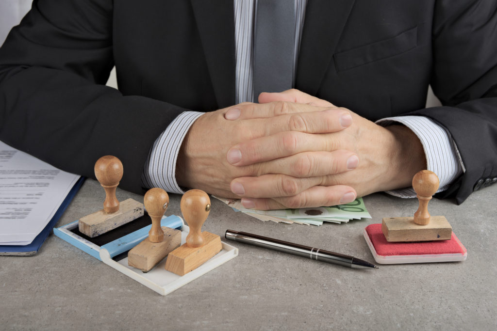Pencil pusher asking for a bribe in euros or in dollars